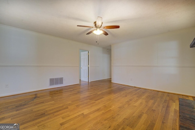 empty room with crown molding, ceiling fan, and light hardwood / wood-style floors