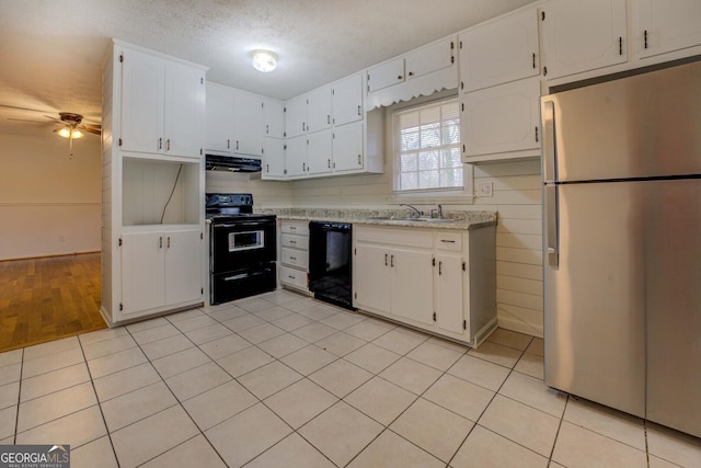 kitchen with sink, white cabinets, light tile patterned floors, ceiling fan, and black appliances