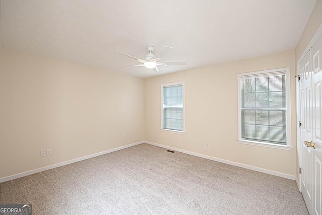 spare room with ceiling fan and carpet floors