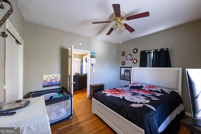 bedroom with ceiling fan, a closet, and wood finished floors