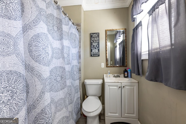 bathroom with ornamental molding, vanity, and toilet