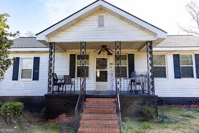 bungalow-style home with a porch, a shingled roof, and ceiling fan