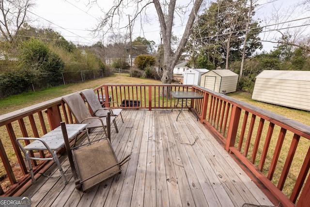 wooden terrace featuring a yard and a storage shed