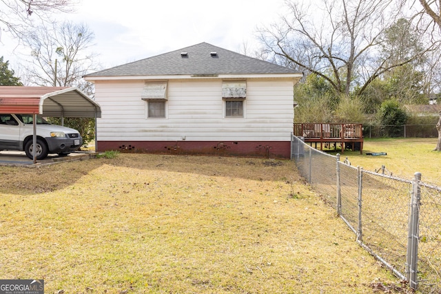 view of property exterior featuring a yard, a deck, and a carport