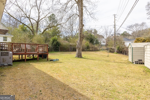 view of yard featuring a storage unit and a deck