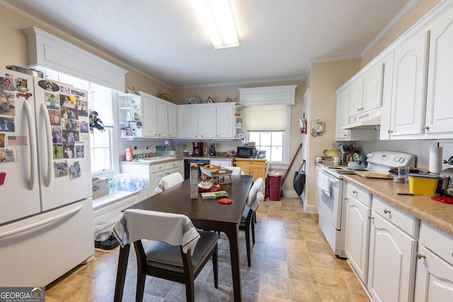 kitchen with sink, ornamental molding, white appliances, and white cabinets