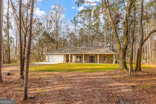 single story home featuring driveway, a chimney, an attached garage, covered porch, and a front lawn