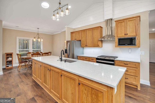 kitchen featuring appliances with stainless steel finishes, a sink, and ornamental molding