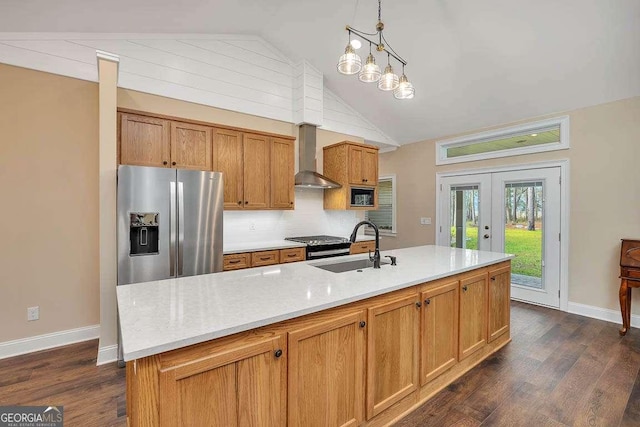 kitchen with french doors, vaulted ceiling, a sink, wall chimney range hood, and stainless steel fridge with ice dispenser