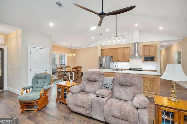 living area with baseboards, visible vents, a ceiling fan, dark wood-type flooring, and vaulted ceiling