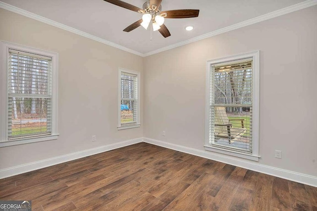 spare room with ceiling fan, baseboards, ornamental molding, and dark wood finished floors