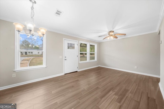 unfurnished living room featuring ornamental molding, ceiling fan with notable chandelier, and wood-type flooring