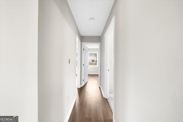 hall with dark hardwood / wood-style flooring