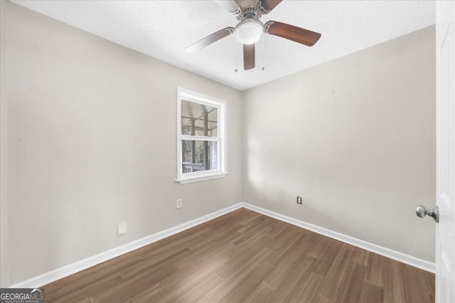 empty room with ceiling fan and hardwood / wood-style floors