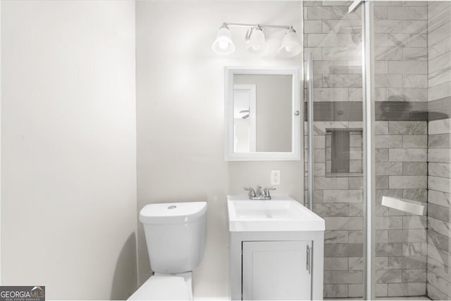 bathroom featuring walk in shower, vanity, and toilet