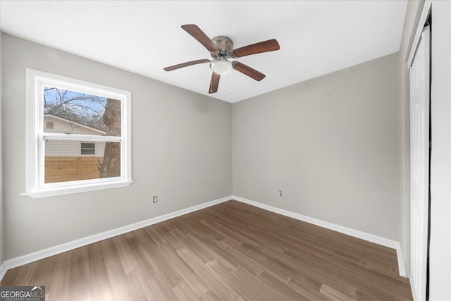 spare room featuring hardwood / wood-style flooring and ceiling fan