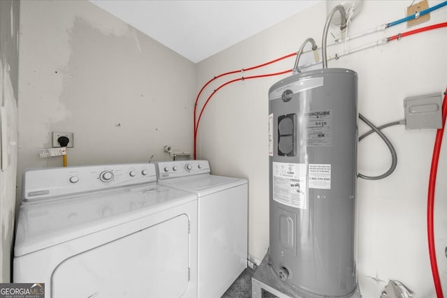 washroom featuring electric water heater and washer and dryer