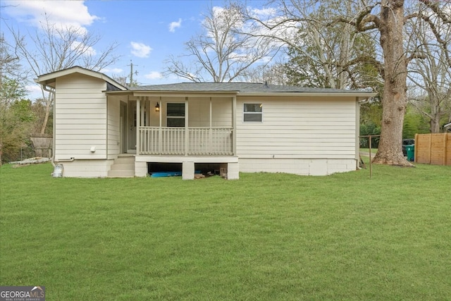 back of property with a porch and a yard