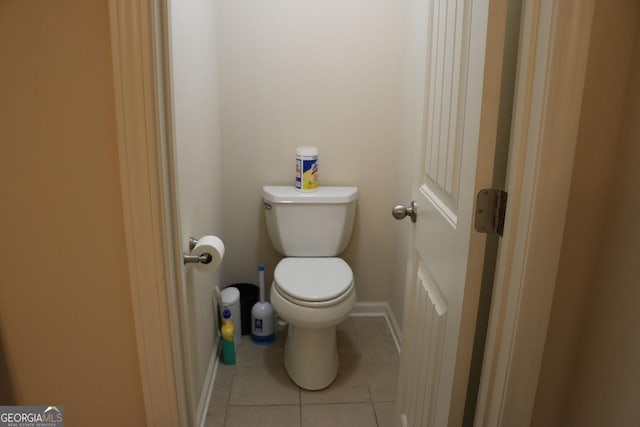 bathroom featuring toilet and tile patterned flooring