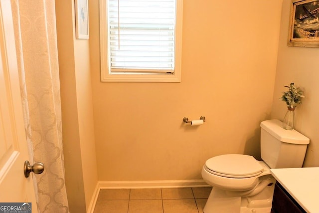 bathroom featuring vanity, tile patterned floors, and toilet