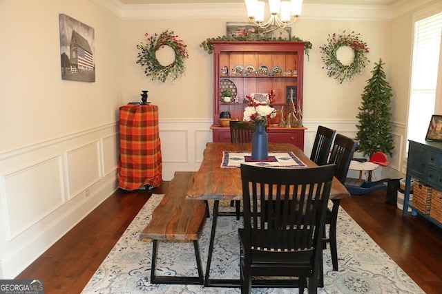 dining room with an inviting chandelier, ornamental molding, and dark hardwood / wood-style floors