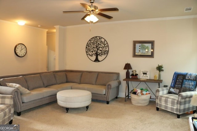 living room featuring ornamental molding, ceiling fan, and carpet