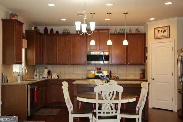 kitchen featuring pendant lighting, light stone countertops, stainless steel appliances, and a kitchen bar