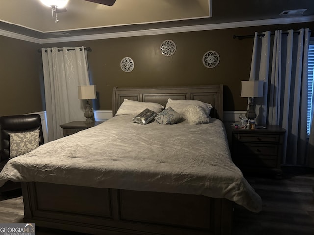 bedroom with crown molding, ceiling fan, and wood finished floors