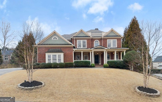 view of front of home with a front yard and covered porch