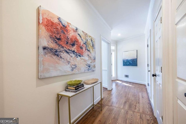 hallway featuring ornamental molding and hardwood / wood-style floors