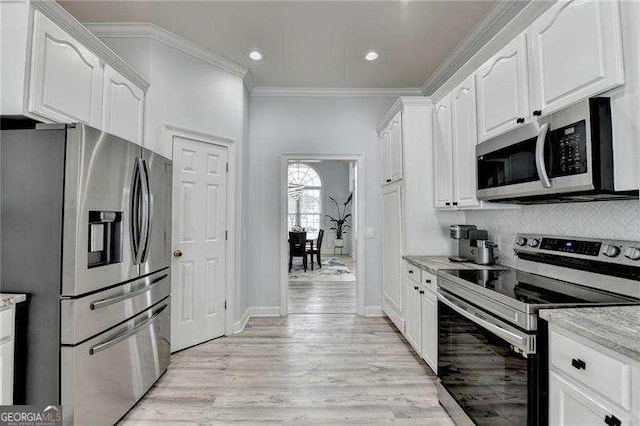 kitchen featuring crown molding, tasteful backsplash, stainless steel appliances, light stone countertops, and white cabinets