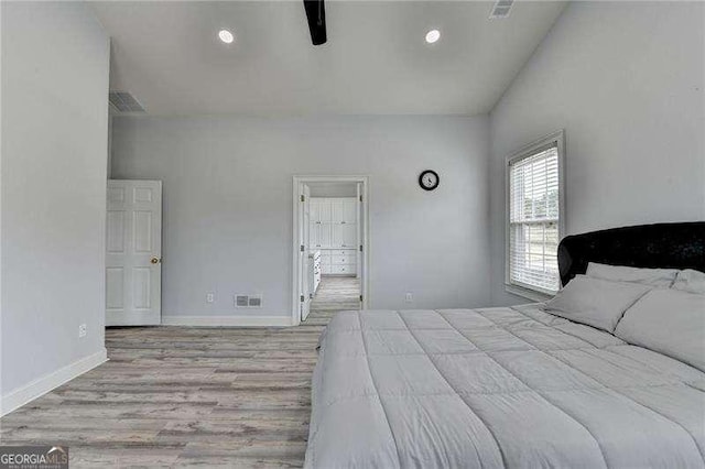 unfurnished bedroom with ceiling fan, high vaulted ceiling, and light hardwood / wood-style flooring