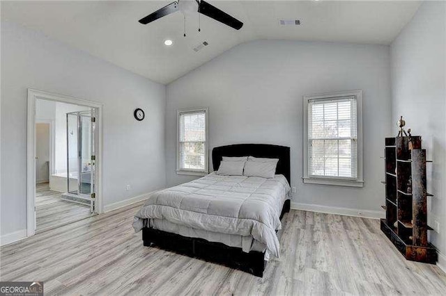 bedroom featuring vaulted ceiling, ceiling fan, light hardwood / wood-style floors, and multiple windows