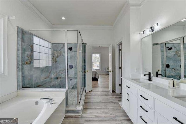 bathroom with vanity, hardwood / wood-style floors, ornamental molding, and separate shower and tub