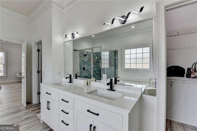 bathroom featuring crown molding, vanity, an enclosed shower, and hardwood / wood-style flooring