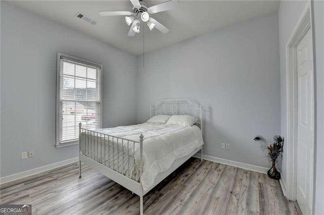 bedroom with wood-type flooring and ceiling fan