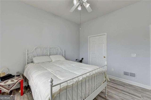 bedroom with hardwood / wood-style flooring and ceiling fan