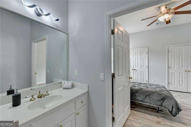 bathroom featuring vanity, wood-type flooring, and ceiling fan