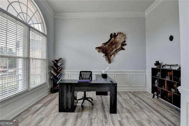 office with crown molding and light hardwood / wood-style flooring