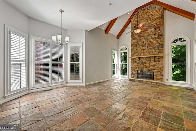 unfurnished living room featuring a stone fireplace, ceiling fan with notable chandelier, high vaulted ceiling, and beamed ceiling