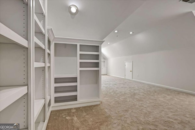 spacious closet featuring lofted ceiling and carpet flooring