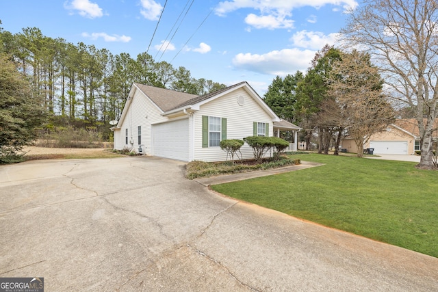 view of side of home with a garage and a lawn