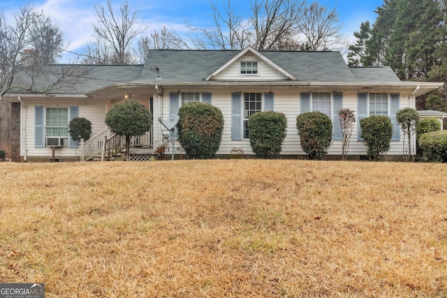 ranch-style home with a front yard and cooling unit