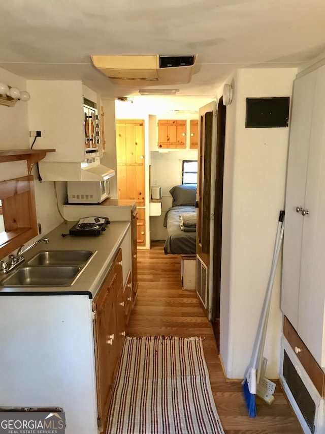 kitchen with sink and light hardwood / wood-style floors