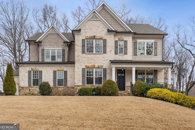 craftsman-style house featuring a front lawn and covered porch