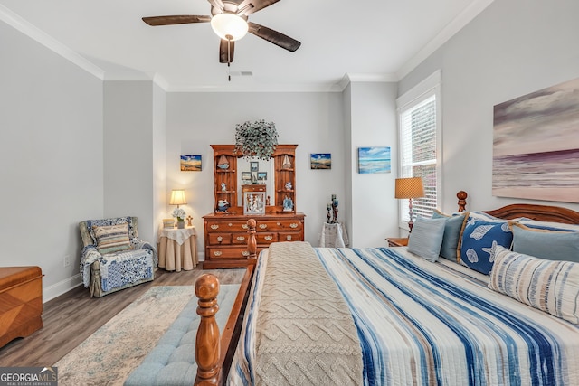 bedroom with crown molding, ceiling fan, and hardwood / wood-style floors