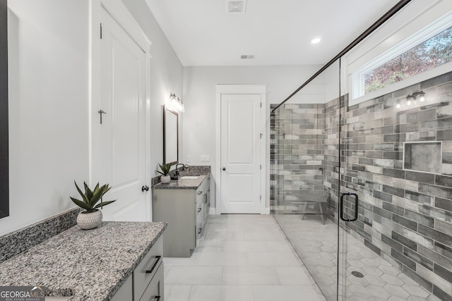 bathroom featuring vanity and a shower with shower door