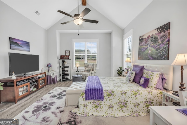 bedroom featuring ceiling fan, high vaulted ceiling, and light wood-type flooring