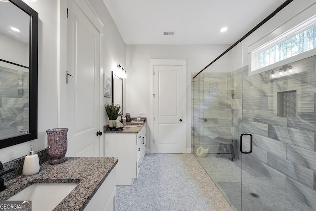 bathroom with vanity and an enclosed shower