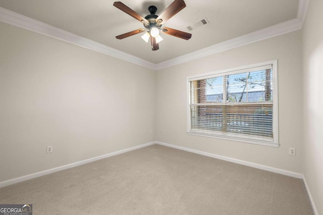 carpeted spare room featuring ornamental molding and ceiling fan